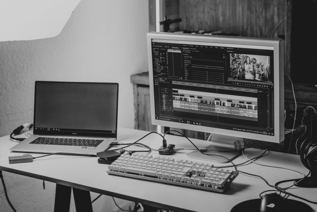 Laptop and computer on a desk set up for video editing